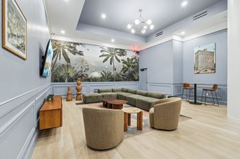 A living room with a couch, chairs, and a coffee table.